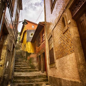 HDR colour image of a pedestrian laneway in Porto, looking up steep steps with terrace houses on either side